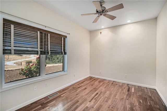 spare room featuring hardwood / wood-style flooring and ceiling fan