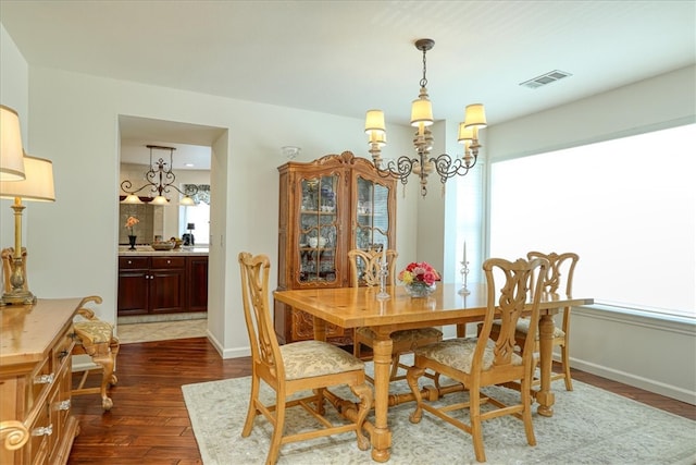 dining area featuring an inviting chandelier and dark hardwood / wood-style floors