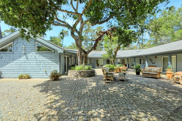 rear view of house featuring an outdoor hangout area and a patio area