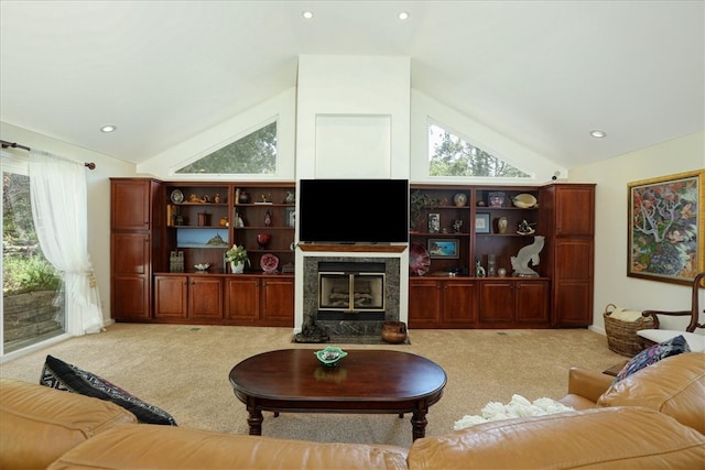 living room featuring a premium fireplace, lofted ceiling, and light colored carpet