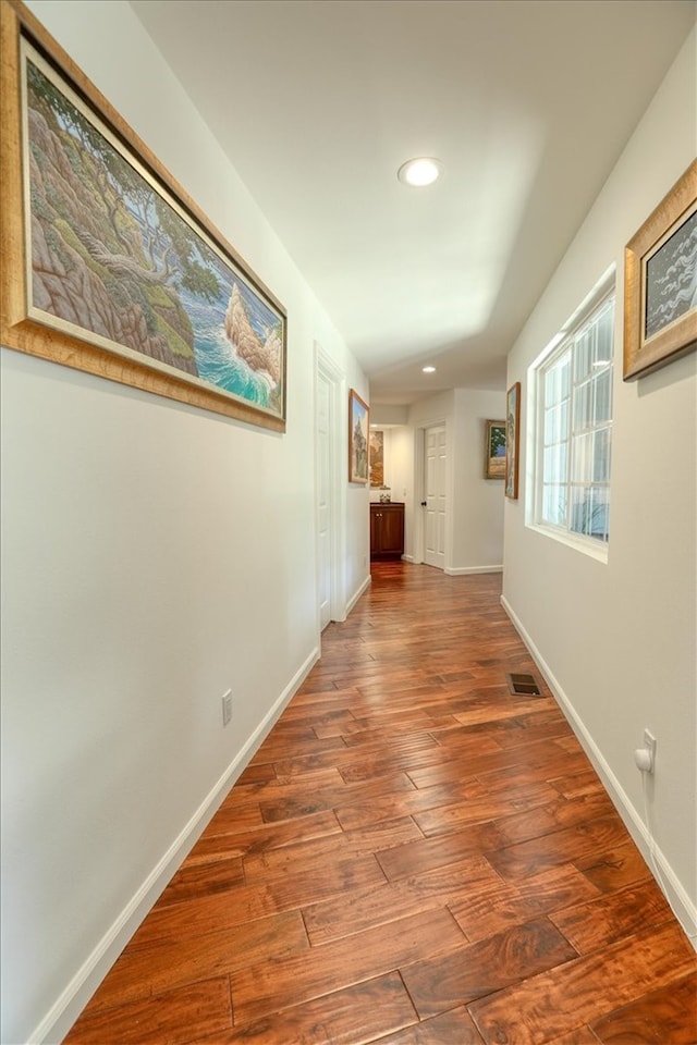 corridor featuring wood-type flooring