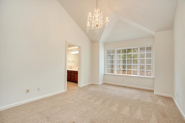 unfurnished room with high vaulted ceiling, light colored carpet, and a chandelier