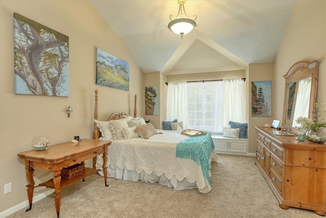 carpeted bedroom with lofted ceiling