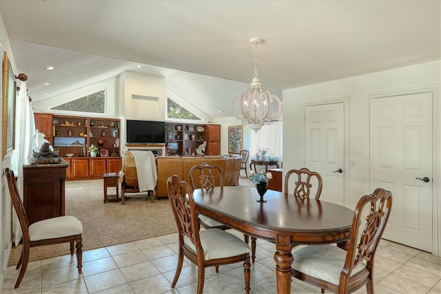 dining space with vaulted ceiling, light tile patterned floors, and an inviting chandelier