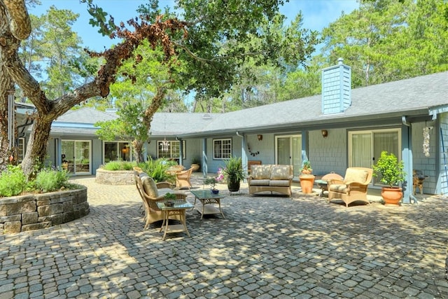 rear view of house with an outdoor hangout area and a patio area