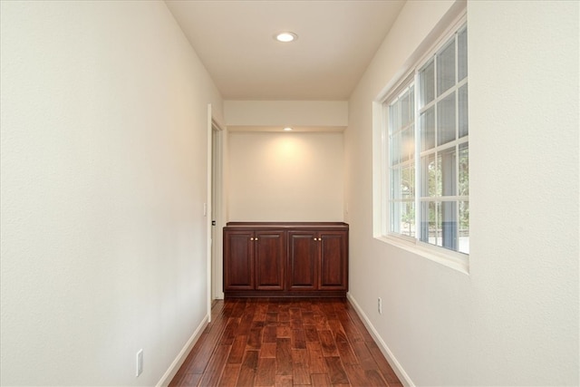 hallway with dark hardwood / wood-style floors