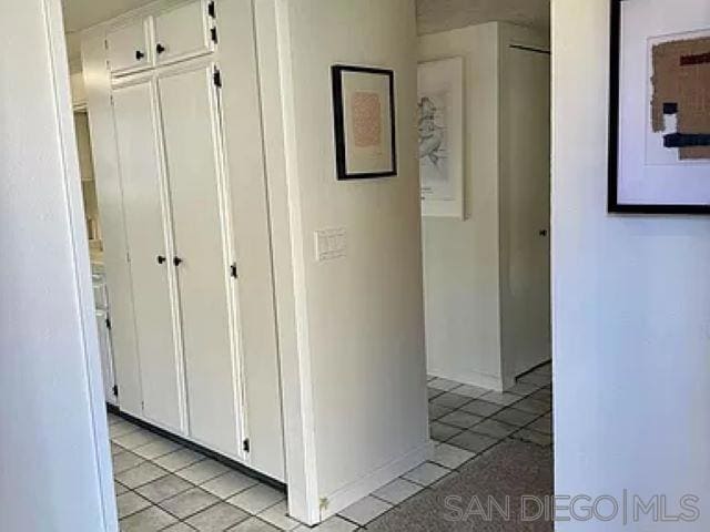 corridor featuring light tile patterned flooring