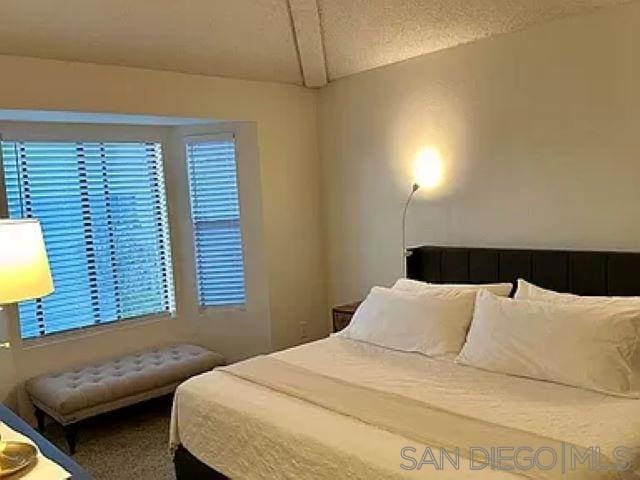 bedroom with carpet and a textured ceiling