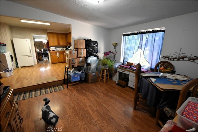 interior space with a textured ceiling and hardwood / wood-style floors