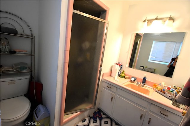 bathroom with walk in shower, vanity, and toilet