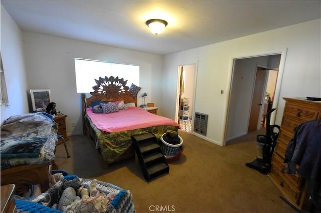 bedroom featuring baseboards, carpet flooring, and heating unit