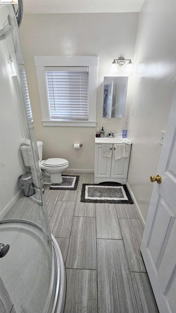 bathroom featuring hardwood / wood-style floors, vanity, and toilet