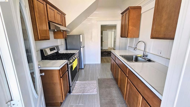 kitchen with stainless steel appliances, dark wood-type flooring, and sink