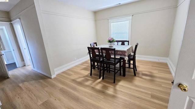 dining space with hardwood / wood-style flooring