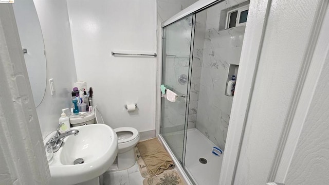 bathroom featuring sink, walk in shower, and toilet