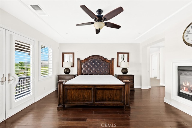 bedroom featuring ceiling fan, dark hardwood / wood-style floors, and access to exterior