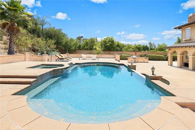 view of pool with a patio and an in ground hot tub