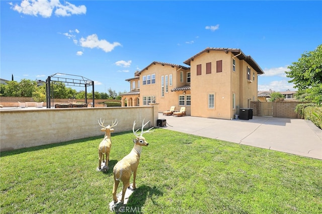 back of property featuring a patio and a yard