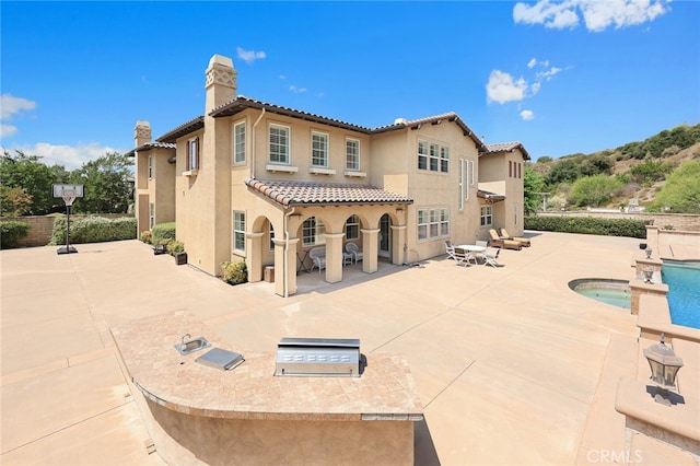 back of property featuring a patio