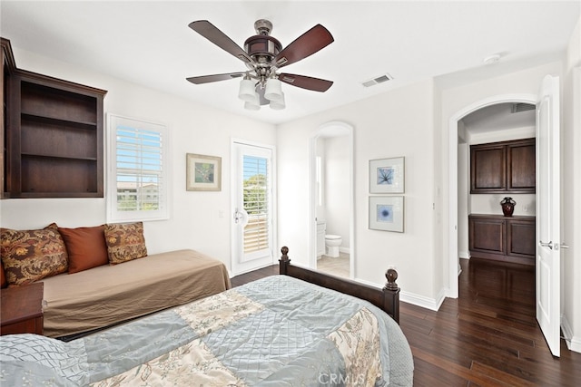 bedroom featuring ceiling fan, access to exterior, ensuite bath, and dark hardwood / wood-style flooring