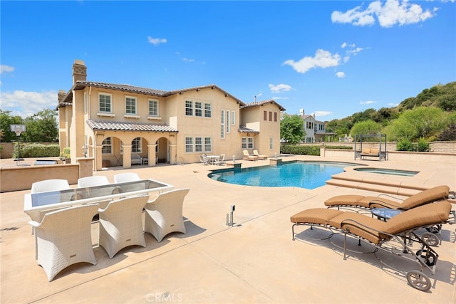 view of swimming pool featuring a patio and an outdoor bar