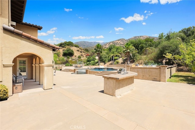 view of patio / terrace with a mountain view