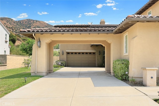 view of front of house with a mountain view, a front lawn, and a garage