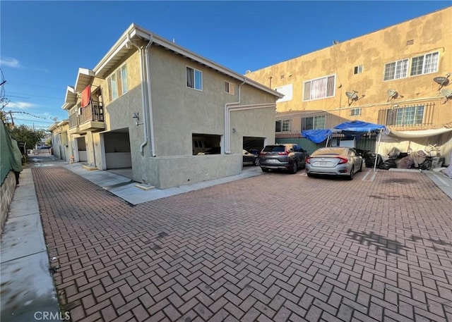exterior space featuring a balcony and stucco siding