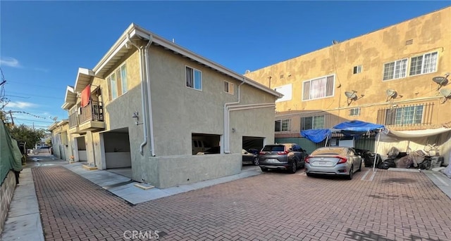 exterior space featuring stucco siding and a balcony