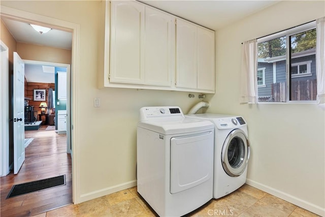 washroom with cabinets and separate washer and dryer