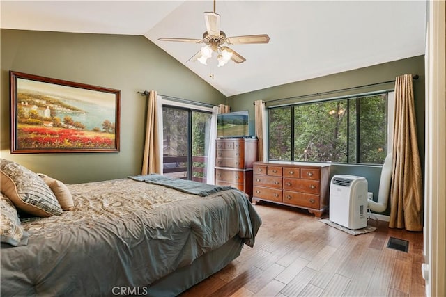 bedroom featuring ceiling fan, light hardwood / wood-style floors, and lofted ceiling