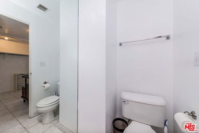 bathroom featuring toilet and tile patterned floors