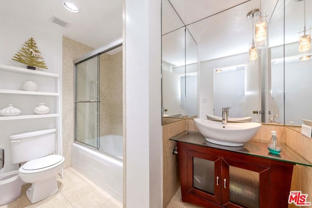 full bathroom with toilet, vanity, shower / bath combination with glass door, and tile patterned flooring