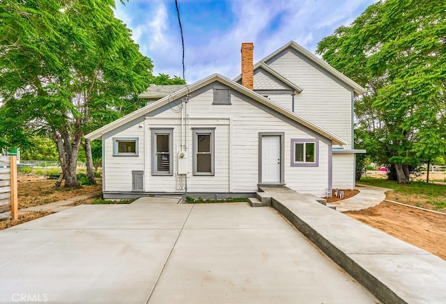 back of property with a patio