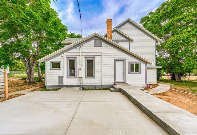 21457 Pecan St, Wildomar, CA 92595 - rear view of property featuring a chimney