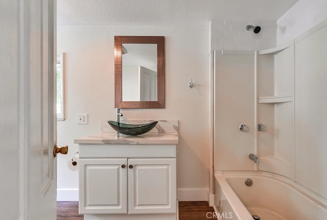 bathroom with vanity, shower / washtub combination, and hardwood / wood-style floors