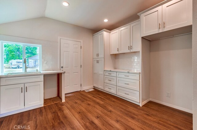 21457 Pecan St, Wildomar, CA 92595 - kitchen featuring dark wood finished floors, decorative backsplash, light countertops, white cabinets, and vaulted ceiling