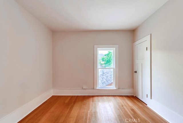 unfurnished room with light wood-type flooring