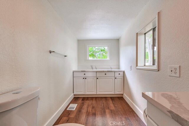 21457 Pecan St, Wildomar, CA 92595 - laundry room with dark wood-style flooring, a textured wall, and a textured ceiling