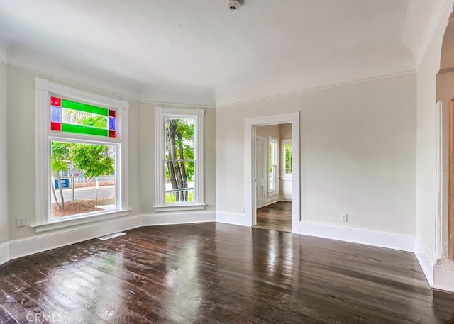 empty room with dark hardwood / wood-style flooring