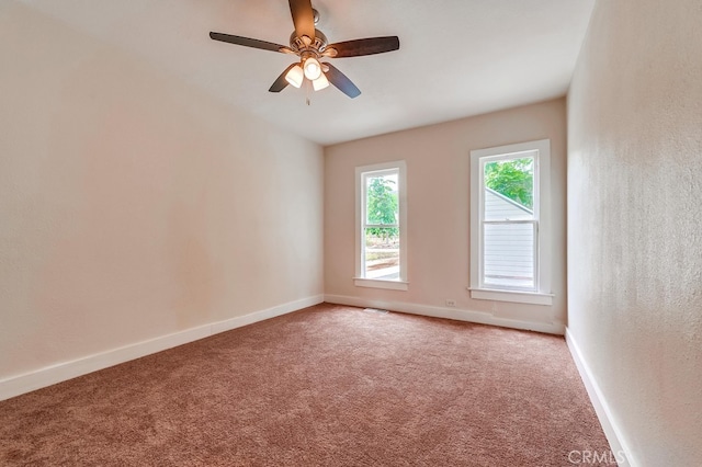 spare room featuring carpet and ceiling fan