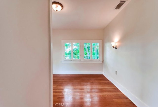 unfurnished room with wood-type flooring