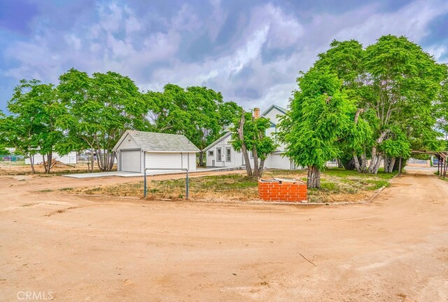21457 Pecan St, Wildomar, CA 92595 - view of front of home featuring a detached garage, driveway, and an outdoor structure