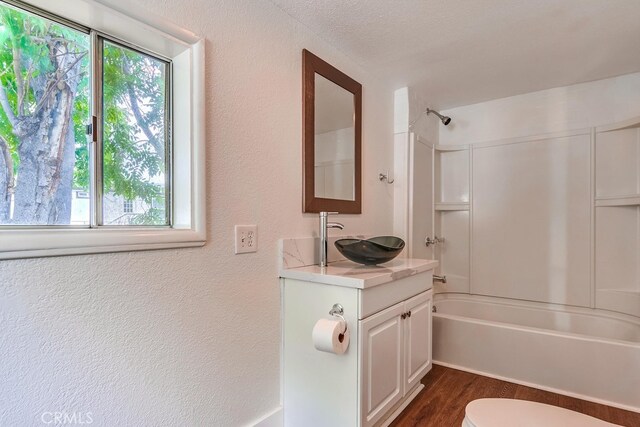 21457 Pecan St, Wildomar, CA 92595 - full bath with vanity, shower / tub combination, wood finished floors, and a textured wall