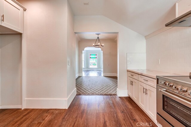 21457 Pecan St, Wildomar, CA 92595 - kitchen with stainless steel range, range hood, dark wood finished floors, lofted ceiling, and white cabinetry
