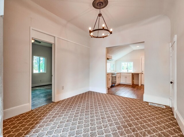 21457 Pecan St, Wildomar, CA 92595 - carpeted empty room with a chandelier, lofted ceiling, and wood finished floors