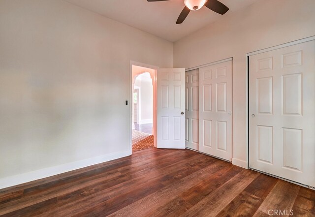 21457 Pecan St, Wildomar, CA 92595 - unfurnished bedroom featuring dark wood finished floors, arched walkways, and ceiling fan