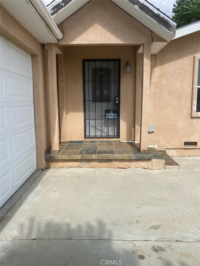 view of exterior entry with a garage