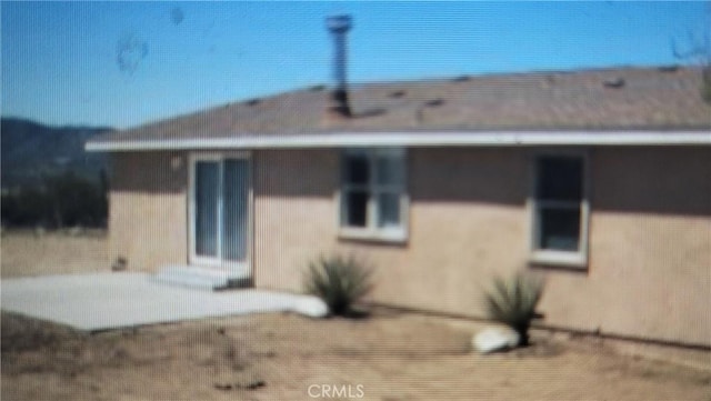 rear view of property featuring a patio area