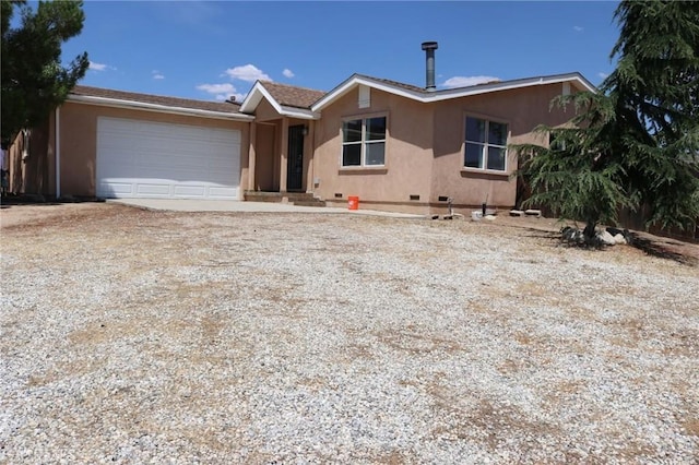 ranch-style house with stucco siding, driveway, crawl space, and a garage